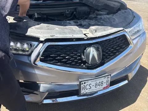 Pet transport car with the hood open after traffic and transmission trouble in Mexico
